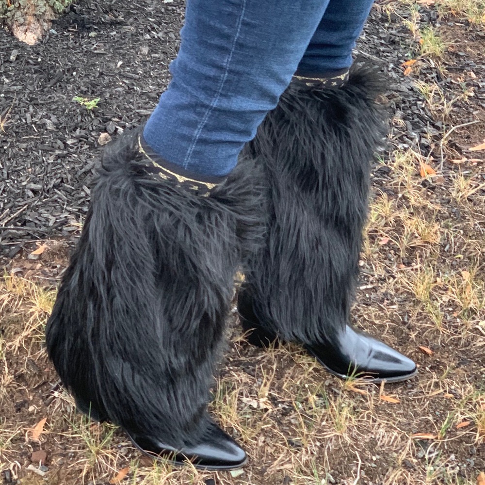 Black extra fluffy faux fur leg warmers with gold and black chain link detail.